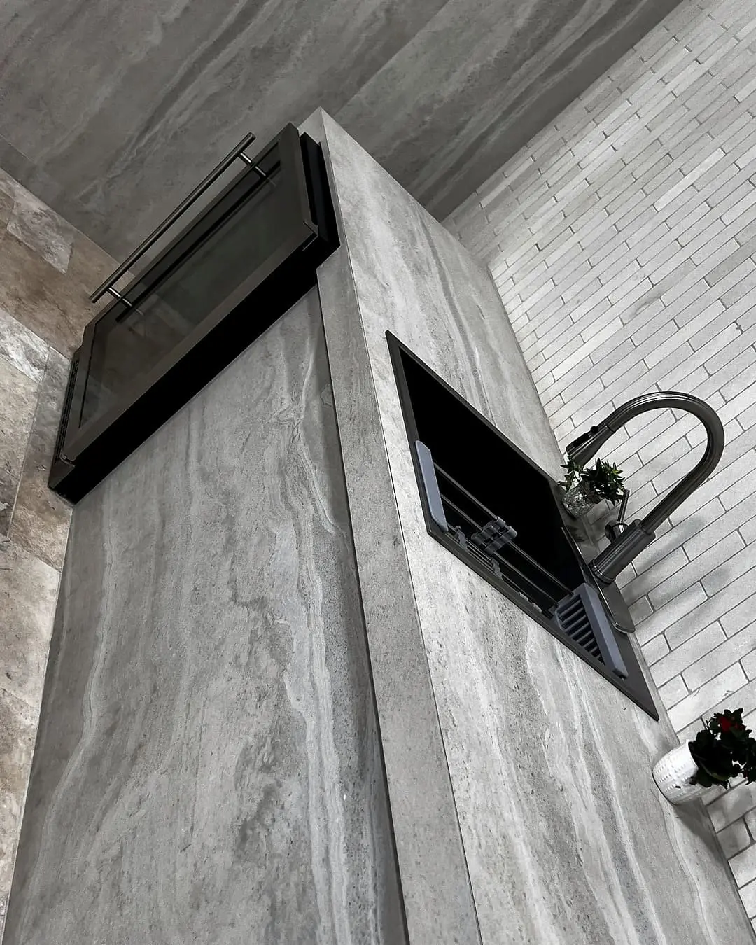 Kitchen island with marble stone cladding